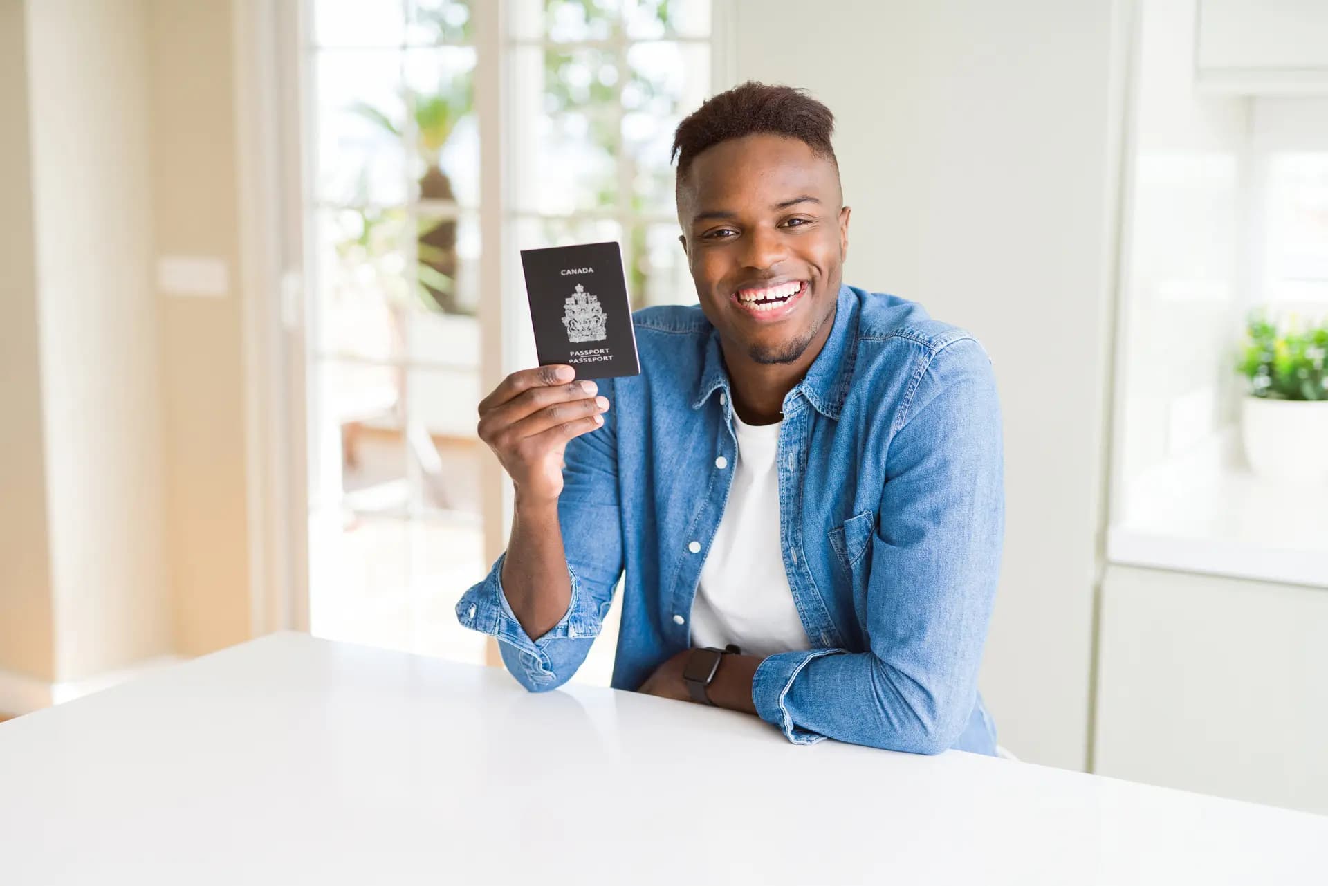 Man holding a Canadian passport representing the immigration pathway advantage of French proficiency