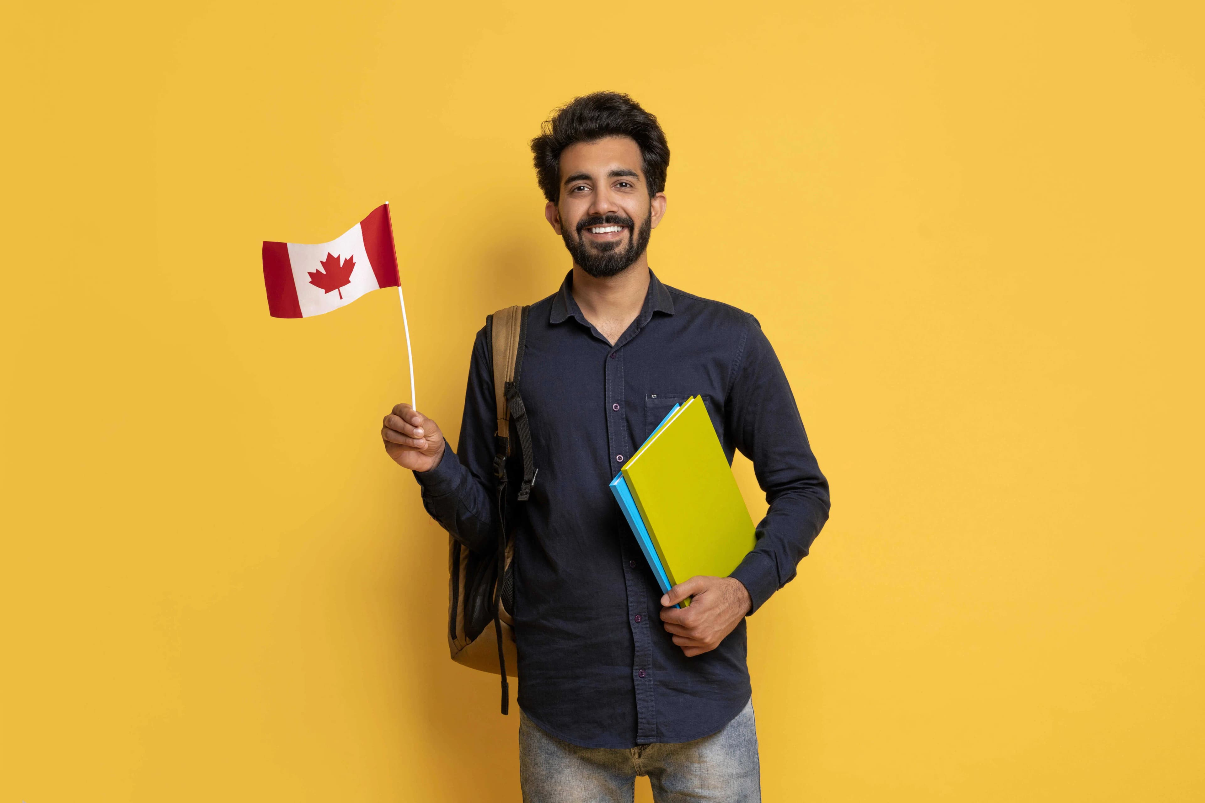 Student with Canadian flag and workbook studying language benchmarks